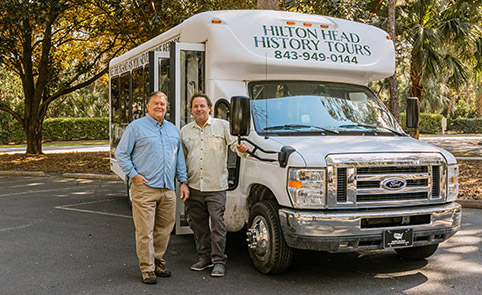 Tour Guides pictured in front of tour bus