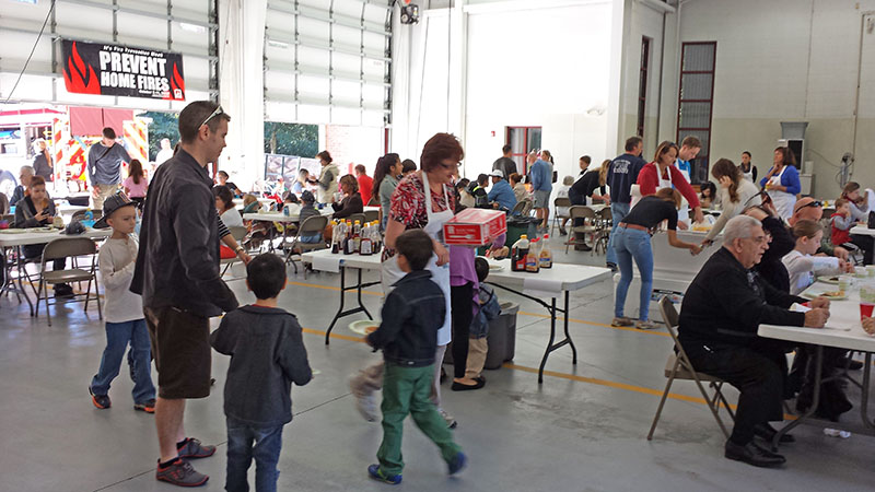 Parents and kids at tables in Fire Station Bay